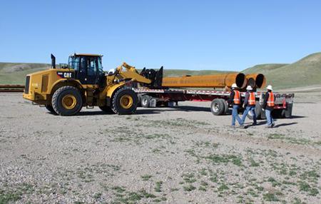 Poles for the Montana-Alberta Tie Line are unloaded outside Shelby, Mont. | Photo courtesy of Tonbridge Power Poles for the Montana-Alberta Tie Line are unloaded outside Shelby, Mont. | Photo courtesy of Tonbridge Power