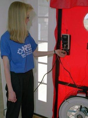 Kendra now works in weatherization, part of which often includes using blower door testing equipment to find air leaks, much like the equipment used here by an NREL worker. | File photo Kendra now works in weatherization, part of which often includes using blower door testing equipment to find air leaks, much like the equipment used here by an NREL worker. | File photo