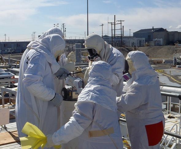 Standing near a pipe providing access to the tank below, workers initiate a water soak aimed at loosening hard-to-remove-waste from the bottom of the underground tank known as C-109. Standing near a pipe providing access to the tank below, workers initiate a water soak aimed at loosening hard-to-remove-waste from the bottom of the underground tank known as C-109.