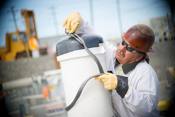 A crane and rigging worker prepares to lift equipment into position near C-104, one of three underground waste storage tanks emptied this year at Hanford. A crane and rigging worker prepares to lift equipment into position near C-104, one of three underground waste storage tanks emptied this year at Hanford.