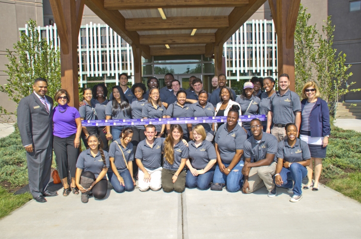 Students celebrate the ribbon cutting at their energy efficient housing center. | Photo courtesy of the University at Albany. Students celebrate the ribbon cutting at their energy efficient housing center. | Photo courtesy of the University at Albany.
