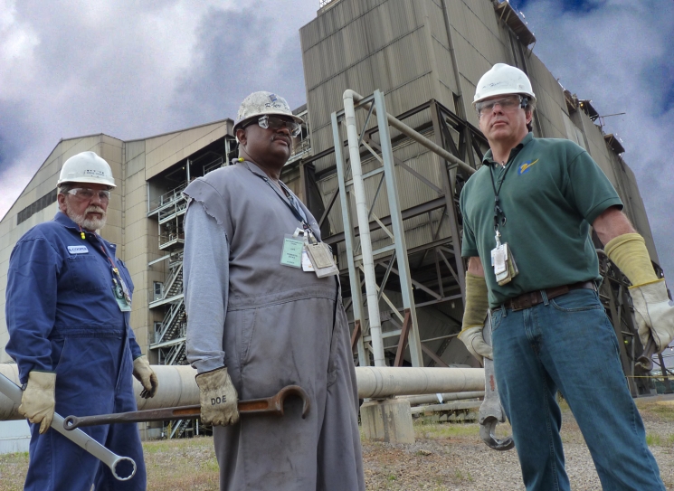 SRNS Maintenance Supervisor Steve Cooper, left to right, Control Room Operator Robert Dicks, and Deputy Operations Manager Ren
Hatfield stand near a boiler unit of the DArea powerhouse. The three workers have a combined experience of 83 years at the facility. SRNS Maintenance Supervisor Steve Cooper, left to right, Control Room Operator Robert Dicks, and Deputy Operations Manager Ren
Hatfield stand near a boiler unit of the DArea powerhouse. The three workers have a combined experience of 83 years at the facility.