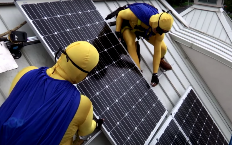 Solar installers dressed up as superheroes to complete the installation on the KidsQuest Children̢۪s Museum in Washington as part of the Solarize Bellevue campaign. Photo by Allison DeAngelis. Solar installers dressed up as superheroes to complete the installation on the KidsQuest Children̢۪s Museum in Washington as part of the Solarize Bellevue campaign. Photo by Allison DeAngelis.