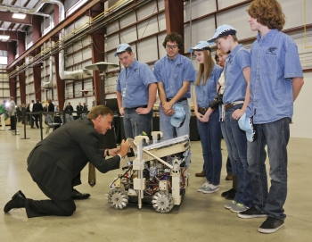 Tennessee Governor Bill Haslam signs the robot of Hardin Valley Academy's FIRST robotics team during the dedication of DOE's Carbon Fiber Technology Facility, located at Oak Ridge National Laboratory. The RoHAWKtics team (named after their school mascot) spent an intense six weeks constructing the robot, using design, engineering, and problem-solving skills. The team will be moving on to a national competition in April. Learn more about the <a href="http://www.ornl.gov/info/features/get_feature.cfm?FeatureNumber=f20130401-00">FIRST competition</a>. | Photo courtesy of Oak Ridge National Laboratory. Tennessee Governor Bill Haslam signs the robot of Hardin Valley Academy's FIRST robotics team during the dedication of DOE's Carbon Fiber Technology Facility, located at Oak Ridge National Laboratory. The RoHAWKtics team (named after their school mascot) spent an intense six weeks constructing the robot, using design, engineering, and problem-solving skills. The team will be moving on to a national competition in April. Learn more about the <a href="http://www.ornl.gov/info/features/get_feature.cfm?FeatureNumber=f20130401-00">FIRST competition</a>. | Photo courtesy of Oak Ridge National Laboratory.
