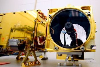 On August 5, 2012, the Curiosity rover touched down on the surface of Mars. The ChemCam instrument package, developed at Los Alamos National Laboratory, is a device mounted on the Mars Curiosity rover that uses two remote sensing instruments: the Laser-Induced Breakdown Spectrometer (LIBS) and a Remote Micro-Imager (RMI). The LIBS fires a powerful laser that determines chemical compositions of rock and soil samples, while the RMI takes photos of the samples within the rover's vicinity. In this photo, the ChemCam is being prepared in the clean room prior to the launch of NASA's Mars Science Laboratory mission. <a href="http://mars.jpl.nasa.gov/msl/mission/instruments/spectrometers/chemcam/" target="_blank">Learn more about the ChemCam</a>. | Photo courtesy of Los Alamos National Laboratory. On August 5, 2012, the Curiosity rover touched down on the surface of Mars. The ChemCam instrument package, developed at Los Alamos National Laboratory, is a device mounted on the Mars Curiosity rover that uses two remote sensing instruments: the Laser-Induced Breakdown Spectrometer (LIBS) and a Remote Micro-Imager (RMI). The LIBS fires a powerful laser that determines chemical compositions of rock and soil samples, while the RMI takes photos of the samples within the rover's vicinity. In this photo, the ChemCam is being prepared in the clean room prior to the launch of NASA's Mars Science Laboratory mission. <a href="http://mars.jpl.nasa.gov/msl/mission/instruments/spectrometers/chemcam/" target="_blank">Learn more about the ChemCam</a>. | Photo courtesy of Los Alamos National Laboratory.