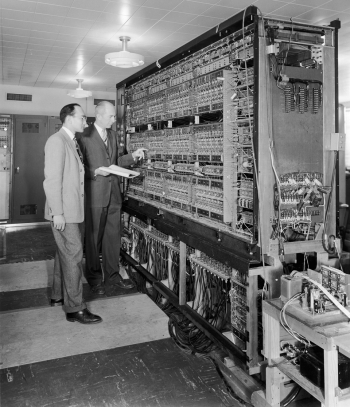 In this photo, two Argonne researchers are pictured with Argonne's first digital computer, AVIDAC. Designed and built by Argonne's Physics Division for $250,000, it began operations on January 28, 1953. AVIDAC stands for "Argonne Version of the Institute's Digital Automatic Computer" and was based on architecture developed by mathematician John von Neumann. Groundbreaking as it was, today's smartphones are far more sophisticated and powerful than this machine. | Photo courtesy of Argonne National Laboratory. In this photo, two Argonne researchers are pictured with Argonne's first digital computer, AVIDAC. Designed and built by Argonne's Physics Division for $250,000, it began operations on January 28, 1953. AVIDAC stands for "Argonne Version of the Institute's Digital Automatic Computer" and was based on architecture developed by mathematician John von Neumann. Groundbreaking as it was, today's smartphones are far more sophisticated and powerful than this machine. | Photo courtesy of Argonne National Laboratory.