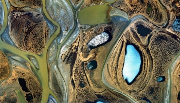 This aerial photo shows open water and floating ice on ponds, lakes and river channels in the Sagavanirktok River Delta in Alaskaâs North Slope. PNNL scientists employed satellite technology to understand the impacts of oil development activities on the environment. Using satellite radar to âseeâ through the ice, scientists detected critical fish overwintering habitats by identifying where ice was grounded and where it was floating.
Utilizing this information on critical habitats, fishery managers can suggest locations for energy development activities that increase the sustainability of fishery resources and minimize environmental impacts. Research was funded by the U.S. Department of the Interior. | Photo courtesy of Pacific Northwest National Laboratory. This aerial photo shows open water and floating ice on ponds, lakes and river channels in the Sagavanirktok River Delta in Alaskaâs North Slope. PNNL scientists employed satellite technology to understand the impacts of oil development activities on the environment. Using satellite radar to âseeâ through the ice, scientists detected critical fish overwintering habitats by identifying where ice was grounded and where it was floating.
Utilizing this information on critical habitats, fishery managers can suggest locations for energy development activities that increase the sustainability of fishery resources and minimize environmental impacts. Research was funded by the U.S. Department of the Interior. | Photo courtesy of Pacific Northwest National Laboratory.