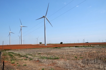A tractor tills the soil among wind turbines in Oklahoma on August 13, 2009. USDA photo by Alice Welch. A tractor tills the soil among wind turbines in Oklahoma on August 13, 2009. USDA photo by Alice Welch.