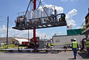 A crane lifts the carbon treatment system into place. This technology treats vapor pumped to the surface by the belowground heating system. A crane lifts the carbon treatment system into place. This technology treats vapor pumped to the surface by the belowground heating system.