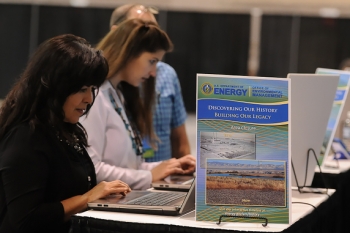 Visitors to EM's booth at the annual Waste Management Symposia international conference participate in demonstrations of the new timeline. Visitors to EM's booth at the annual Waste Management Symposia international conference participate in demonstrations of the new timeline.