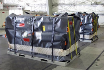 The new soft-sided overpack is placed for shipment for treatment and repackaging. The new soft-sided overpack is placed for shipment for treatment and repackaging.