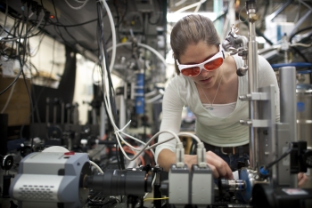 NREL researcher Kirsten Alberi works in the luminescence mapping laboratory at the Solar Energy Research Facility (SERF). Here she aligns a laser and sample to map the photoluminescence coming off the sample. | Photo by Dennis Schroeder, NREL. NREL researcher Kirsten Alberi works in the luminescence mapping laboratory at the Solar Energy Research Facility (SERF). Here she aligns a laser and sample to map the photoluminescence coming off the sample. | Photo by Dennis Schroeder, NREL.
