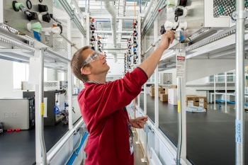 NREL researcher Guido Bender works in the Fuel Cell Test and Development Lab at the Energy Systems Integration Facility. | Photo by Dennis Schroeder, NREL. NREL researcher Guido Bender works in the Fuel Cell Test and Development Lab at the Energy Systems Integration Facility. | Photo by Dennis Schroeder, NREL.