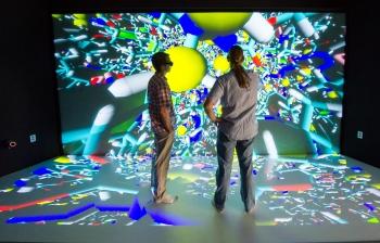 NREL Senior Scientists Ross Larsen and Travis Kemper examine a molecular model using a 3D model at the Insight Collaboration Laboratory during a tour of the Energy Systems Integration Facility. | Photo by Dennis Schroeder, NREL. NREL Senior Scientists Ross Larsen and Travis Kemper examine a molecular model using a 3D model at the Insight Collaboration Laboratory during a tour of the Energy Systems Integration Facility. | Photo by Dennis Schroeder, NREL.