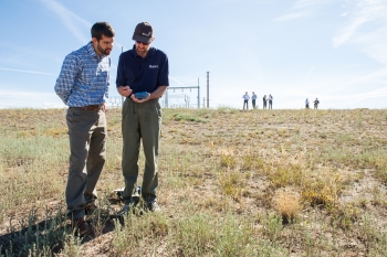 NREL's Otto VanGeet (right) shows James Jensen of Southern Ute Alternative Energy how to use a SunEye tool to check solar availability of the site. Photo by Dennis Schroeder, NREL NREL's Otto VanGeet (right) shows James Jensen of Southern Ute Alternative Energy how to use a SunEye tool to check solar availability of the site. Photo by Dennis Schroeder, NREL