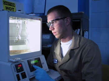 Intern Aleksander Navratil, Carroll College, is setting up to perform viscosity measurements of engine oil formulations for an Argonne National Laboratory program researching oils and additives to improve engine efficiency and reduce emissions. | Photo courtesy of Argonne National Laboratory. Intern Aleksander Navratil, Carroll College, is setting up to perform viscosity measurements of engine oil formulations for an Argonne National Laboratory program researching oils and additives to improve engine efficiency and reduce emissions. | Photo courtesy of Argonne National Laboratory.
