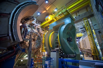 The PHENIX detector at Brookhaven National Lab's Relativistic Heavy Ion Collider (RHIC), a type of particle accelerator, records many different particles emerging from RHIC collisions, including photons, electrons, muons, and quark-containing particles called hadrons. The detector is shown here in a disassembled condition during maintenance. | Photo courtesy of Brookhaven National Laboratory. The PHENIX detector at Brookhaven National Lab's Relativistic Heavy Ion Collider (RHIC), a type of particle accelerator, records many different particles emerging from RHIC collisions, including photons, electrons, muons, and quark-containing particles called hadrons. The detector is shown here in a disassembled condition during maintenance. | Photo courtesy of Brookhaven National Laboratory.