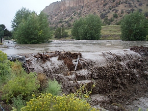 The Los Alamos weir was overrun with flood waters in September. This spring, crews removed 7,200 cubic yards of sediment that accumulated from the September 2013 floods. The Los Alamos weir was overrun with flood waters in September. This spring, crews removed 7,200 cubic yards of sediment that accumulated from the September 2013 floods.