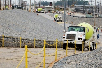 Cement trucks transport a specially formulated grout that is pumped into the waste tanks. Cement trucks transport a specially formulated grout that is pumped into the waste tanks.