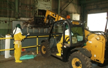 Forklift operator
A spotter, left, helps a forklift driver safely drop debris into a roll-off bin in the Feed Plant. Forklift operator
A spotter, left, helps a forklift driver safely drop debris into a roll-off bin in the Feed Plant.
