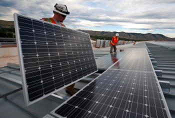Brian Lawson and Kenesaw Burwell install solar panels at the Energy Department's Research Support Facility -- a highly efficient building at the National Renewable Energy Laboratory in Golden, Colorado. | Credit: Dennis Schroeder, NREL. Brian Lawson and Kenesaw Burwell install solar panels at the Energy Department's Research Support Facility -- a highly efficient building at the National Renewable Energy Laboratory in Golden, Colorado. | Credit: Dennis Schroeder, NREL.