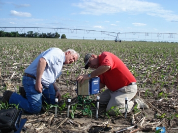 At the University of Nebraska-Lincoln, state energy and extension staff are teaching farmers to use modern sensors to improve irrigation management. In this picture, Darrel Siekman and Gary Zoubek install Watermark Sensors and a data logger. | Photo courtesy of the University of Nebraska. At the University of Nebraska-Lincoln, state energy and extension staff are teaching farmers to use modern sensors to improve irrigation management. In this picture, Darrel Siekman and Gary Zoubek install Watermark Sensors and a data logger. | Photo courtesy of the University of Nebraska.