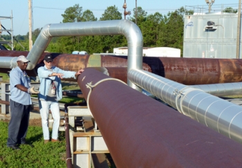 Harrel McCray, left, and Joey Clark, employees with SRS management and operations
contractor, Savannah River Nuclear Solutions, stand by an extensive SRS cleanup system that
safely and successfully rid the site of more than 33,000 gallons of non-radioactive chemical
solvents from 10 million cubic feet of soil through the injection of millions of pounds of steam. Harrel McCray, left, and Joey Clark, employees with SRS management and operations
contractor, Savannah River Nuclear Solutions, stand by an extensive SRS cleanup system that
safely and successfully rid the site of more than 33,000 gallons of non-radioactive chemical
solvents from 10 million cubic feet of soil through the injection of millions of pounds of steam.