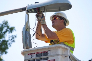 A worker installs energy efficient lights as part of the Smart Lights for Smart Cities program. | Photo courtesy of Mid-America Regional Council. A worker installs energy efficient lights as part of the Smart Lights for Smart Cities program. | Photo courtesy of Mid-America Regional Council.