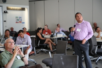 Workshop guest speaker Ken Duncan, Jr. of the San Carlos Apache Tribe told participants about how a 10-kilowatt solar installation at the community radio station not only demonstrated the viability of solar power on the reservation, but also served to keep the radio station functioning and the community informed during recent storm related power outages. Photo by John De La Rosa, NREL Workshop guest speaker Ken Duncan, Jr. of the San Carlos Apache Tribe told participants about how a 10-kilowatt solar installation at the community radio station not only demonstrated the viability of solar power on the reservation, but also served to keep the radio station functioning and the community informed during recent storm related power outages. Photo by John De La Rosa, NREL