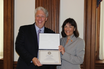 Ronald J. (R.J.) McIntosh receives a Certificate of Special Congressional Recognition from Rep. Suzan DelBene of Washington. | Photo courtesy of Rep. Suzan DelBeneâs office Ronald J. (R.J.) McIntosh receives a Certificate of Special Congressional Recognition from Rep. Suzan DelBene of Washington. | Photo courtesy of Rep. Suzan DelBeneâs office