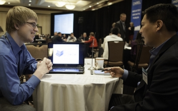 Douglas Hitching (left), CEO of Silicon Solar Solutions and Henry Chung, LG, talk during a one-on-one networking session at the National Renewable Energy Laboratory's Industry Growth Forum in 2012. The SunShot Initiative and the National Renewable Energy Laboratory are hosting a hackathon at the SunShot Grand Challenge Summit as part of an overall effort to lower "soft costs" of solar energy. | Photo by Dennis Schroeder, National Renewable Energy Laboratory Douglas Hitching (left), CEO of Silicon Solar Solutions and Henry Chung, LG, talk during a one-on-one networking session at the National Renewable Energy Laboratory's Industry Growth Forum in 2012. The SunShot Initiative and the National Renewable Energy Laboratory are hosting a hackathon at the SunShot Grand Challenge Summit as part of an overall effort to lower "soft costs" of solar energy. | Photo by Dennis Schroeder, National Renewable Energy Laboratory