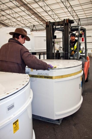 Workers move standard waste boxes to the High-Energy Real Time Radiography facility. Workers move standard waste boxes to the High-Energy Real Time Radiography facility.