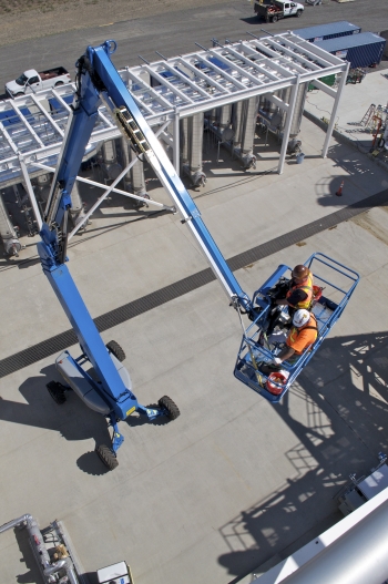 Workers use a lift to access part of the 200 West Groundwater Treatment Facility. Workers use a lift to access part of the 200 West Groundwater Treatment Facility.