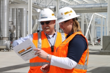Pump-and-treat construction managers David Fink (left) and Delise Pargmann (right) review information for the LEED gold certification of the main process building for the 200 West Groundwater Treatment Facility. Pump-and-treat construction managers David Fink (left) and Delise Pargmann (right) review information for the LEED gold certification of the main process building for the 200 West Groundwater Treatment Facility.