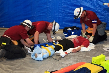 WIPP mine rescue team members simulate the proper first aid response to stabilize injuries. WIPP mine rescue team members simulate the proper first aid response to stabilize injuries.