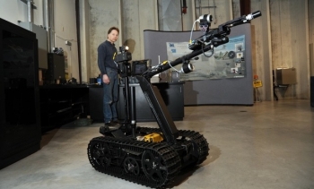 A technician at Idaho National Laboratory demonstrates the modified TALON robot. A technician at Idaho National Laboratory demonstrates the modified TALON robot.