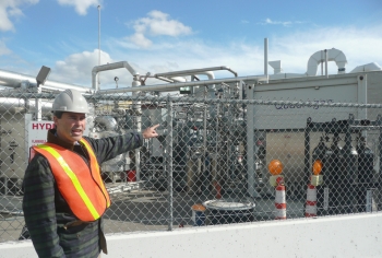Professor Jack Brouwer, Associate Director and Chief Technology Officer of the National Fuel Cell Research Center, points out the tri-generation facility that uses biogas from Orange County Sanitation Districtâs wastewater treatment plant to produce hydrogen, heat and power. | Photo courtesy of the Energy Department. Professor Jack Brouwer, Associate Director and Chief Technology Officer of the National Fuel Cell Research Center, points out the tri-generation facility that uses biogas from Orange County Sanitation Districtâs wastewater treatment plant to produce hydrogen, heat and power. | Photo courtesy of the Energy Department.