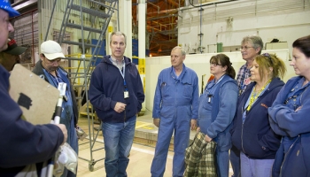 CWI employees discuss safety procedures before they remove a spent nuclear fuel shipment from a shipping container. CWI employees discuss safety procedures before they remove a spent nuclear fuel shipment from a shipping container.