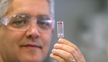 Radiobiologist Matt Coleman displays a device like the medical diagnosis instrument he helped develop for NASA for use in deep space. | Photo by Lawrence Livermore National Laboratory. Radiobiologist Matt Coleman displays a device like the medical diagnosis instrument he helped develop for NASA for use in deep space. | Photo by Lawrence Livermore National Laboratory.