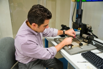 Dr. Anthony Atti, CEO of Phononic Devices, demonstrates the standard semiconductor bonding equipment used to fabricate Phononic's high performance thermoelectric devices. Phononic Devices is one of the five innovative ARPA-E Awardees that have attracted over $100 million in outside capital investments. | Photo Courtesy of Phononic Devices. Dr. Anthony Atti, CEO of Phononic Devices, demonstrates the standard semiconductor bonding equipment used to fabricate Phononic's high performance thermoelectric devices. Phononic Devices is one of the five innovative ARPA-E Awardees that have attracted over $100 million in outside capital investments. | Photo Courtesy of Phononic Devices.