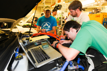 The University of Tennessee - Knoxville team verifies the proper wiring for gear selection before their vehicle is inspected for safety. All teams must pass a safety technical inspection before competing in any driving events. | Photo courtesy of EcoCar 2. The University of Tennessee - Knoxville team verifies the proper wiring for gear selection before their vehicle is inspected for safety. All teams must pass a safety technical inspection before competing in any driving events. | Photo courtesy of EcoCar 2.