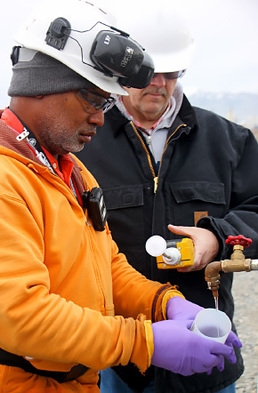 Workers sample a well used to monitor groundwater at the Hanford site. Workers sample a well used to monitor groundwater at the Hanford site.