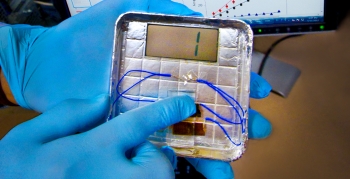 By applying pressure to the generator, one is able to generate about six nanoamperes of current and 400 millivolts of potential -- roughly a quarter of the voltage of a AAA battery and enough to flash a number on the small LCD screen. | Photo courtesy of Seung-Wuk Lee's lab at Lawrence Berkeley National Laboratory. By applying pressure to the generator, one is able to generate about six nanoamperes of current and 400 millivolts of potential -- roughly a quarter of the voltage of a AAA battery and enough to flash a number on the small LCD screen. | Photo courtesy of Seung-Wuk Lee's lab at Lawrence Berkeley National Laboratory.