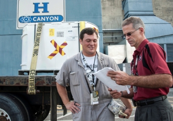 John Barnes, right, discusses a transuranic (TRU) waste container with Charles Fairburn of Savannah River Nuclear Solutions. The TRU waste container was repackaged in the Savannah River Site H-Canyon facility. Barnes has more than 23-years of experience at the Savannah River Site as a Facility Representative. John Barnes, right, discusses a transuranic (TRU) waste container with Charles Fairburn of Savannah River Nuclear Solutions. The TRU waste container was repackaged in the Savannah River Site H-Canyon facility. Barnes has more than 23-years of experience at the Savannah River Site as a Facility Representative.