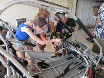 Campers at Camp Discovery put the finishing touches on a newly assembled electric vehicle they built to learn more about EV technology while sharing their experiences with battling cancer. | Photo courtesy of Craig Egan Campers at Camp Discovery put the finishing touches on a newly assembled electric vehicle they built to learn more about EV technology while sharing their experiences with battling cancer. | Photo courtesy of Craig Egan