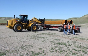 Poles for the Montana-Alberta Tie Line are unloaded outside Shelby, Mont. | Photo courtesy of Tonbridge Power Poles for the Montana-Alberta Tie Line are unloaded outside Shelby, Mont. | Photo courtesy of Tonbridge Power