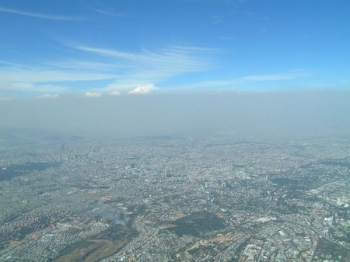 A heavy layer of air pollution, a mix of aerosol particles and vapors, obscures the view over Mexico City. Two studies by the Pacific Northwest National Laboratory show the importance of including the small-scale effects of aerosols in climate modeling. | Image courtesy of PNNL A heavy layer of air pollution, a mix of aerosol particles and vapors, obscures the view over Mexico City. Two studies by the Pacific Northwest National Laboratory show the importance of including the small-scale effects of aerosols in climate modeling. | Image courtesy of PNNL