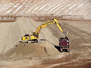 A haul truck carrying a container is loaded with mill tailings at the Moab site. Once loaded and lidded, the container will be placed on a railcar for shipment by train to the Crescent Junction disposal site. A haul truck carrying a container is loaded with mill tailings at the Moab site. Once loaded and lidded, the container will be placed on a railcar for shipment by train to the Crescent Junction disposal site.
