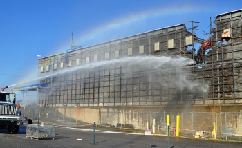 Crews tear though the final wall of Building K-25, bringing an end to the five-year demolition project. Crews tear though the final wall of Building K-25, bringing an end to the five-year demolition project.