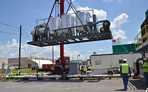A carbon regeneration unit is lowered into place for above ground treatment at the C-400 Cleaning Building. Watch a video of this work here. A carbon regeneration unit is lowered into place for above ground treatment at the C-400 Cleaning Building. Watch a video of this work here.